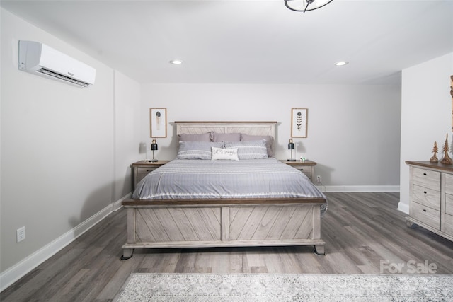 bedroom featuring dark wood-type flooring and a wall mounted AC