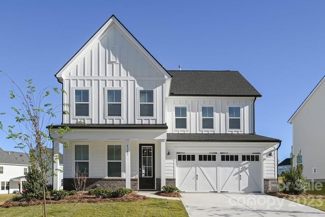 view of front of property with a front yard and a garage