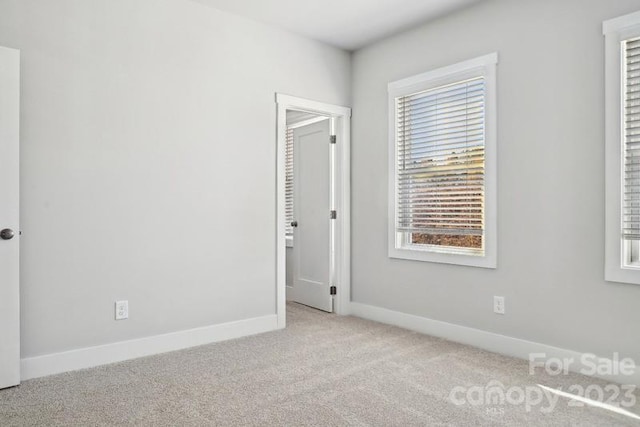 empty room featuring light colored carpet