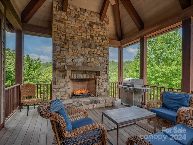 wooden terrace with an outdoor living space with a fireplace