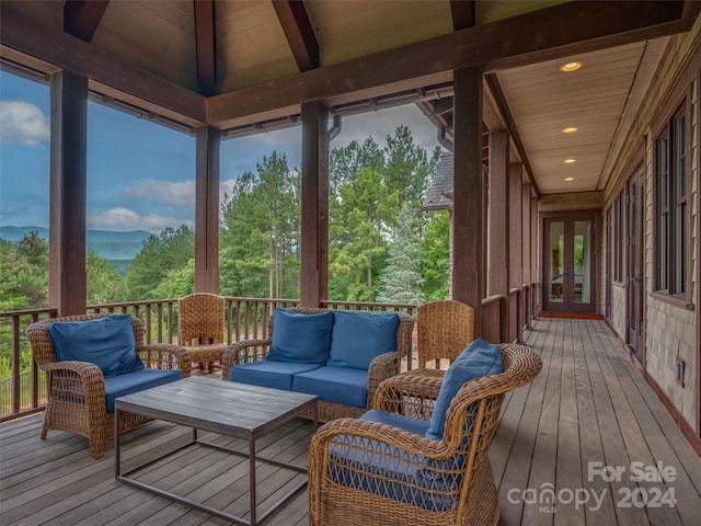 sunroom featuring wood ceiling, french doors, and lofted ceiling with beams