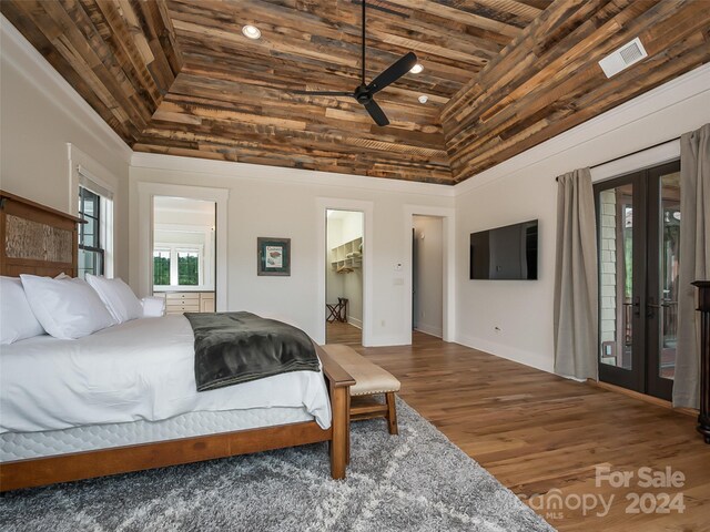 bedroom with a closet, a spacious closet, wooden ceiling, french doors, and dark hardwood / wood-style flooring