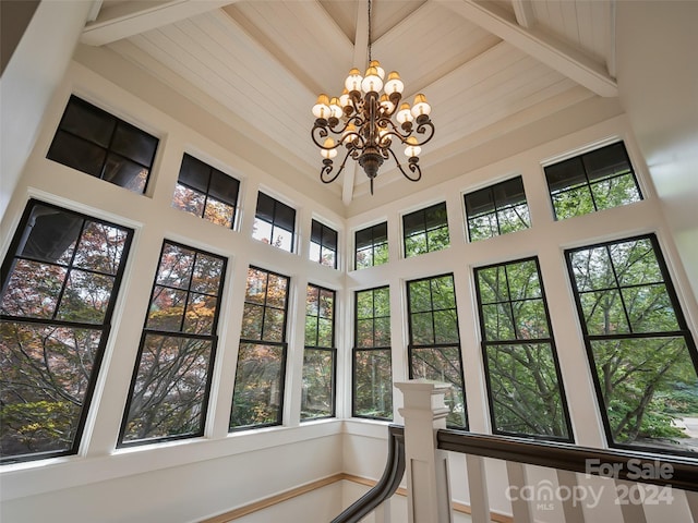 interior details with beam ceiling and a chandelier