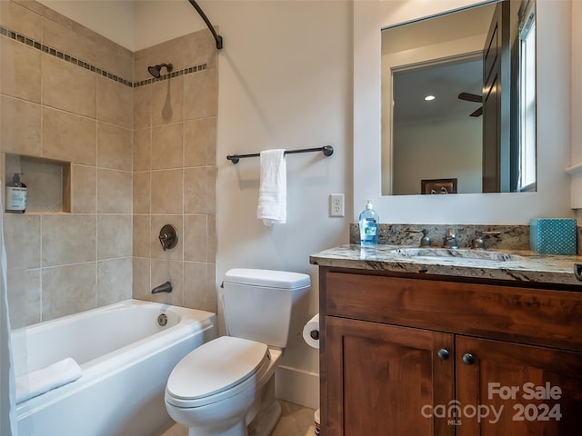 full bathroom featuring vanity, toilet, and tiled shower / bath