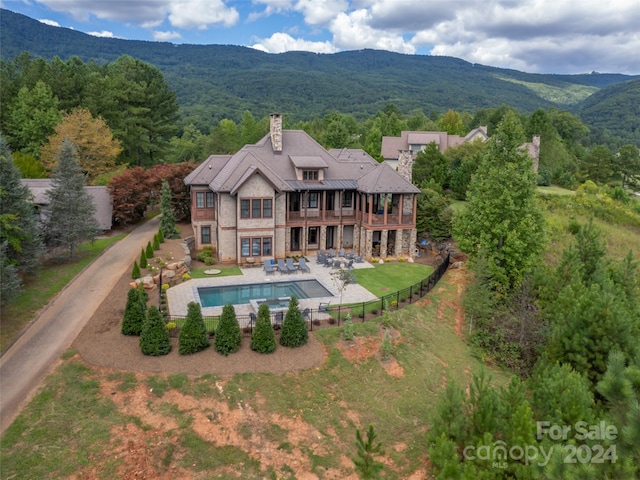 birds eye view of property featuring a mountain view