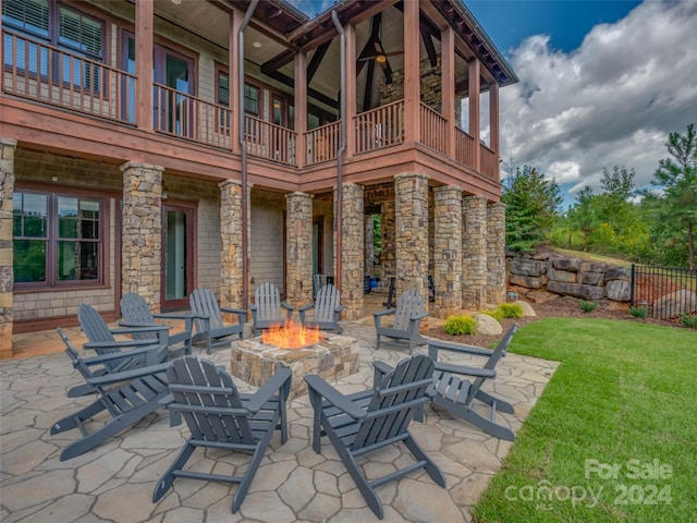 view of patio / terrace with a balcony and a fire pit