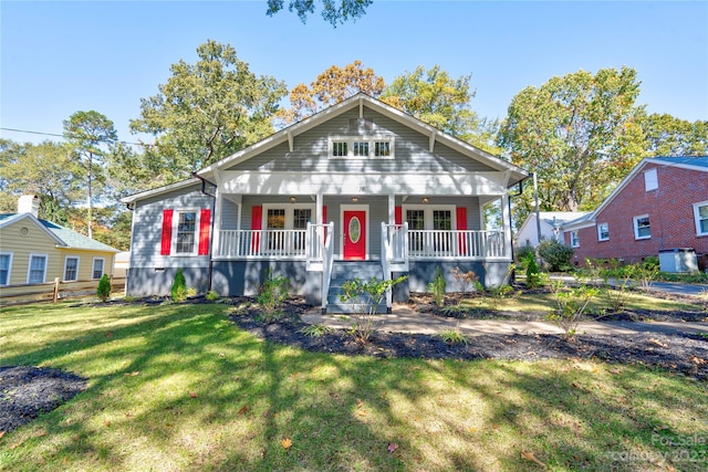 bungalow-style house featuring covered porch and a front lawn