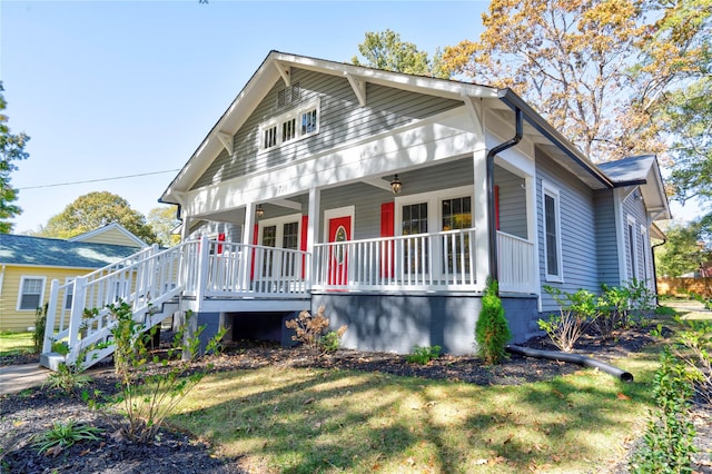 view of front facade with a front yard and a porch