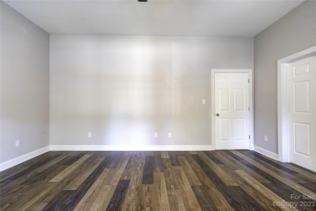 spare room with dark hardwood / wood-style flooring