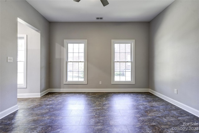 tiled empty room with ceiling fan