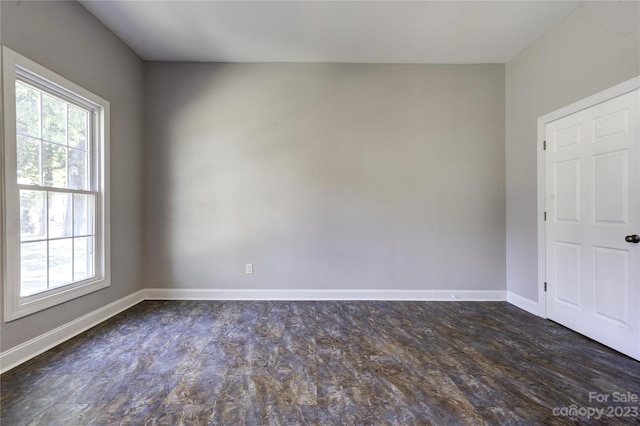 unfurnished room featuring dark wood-type flooring