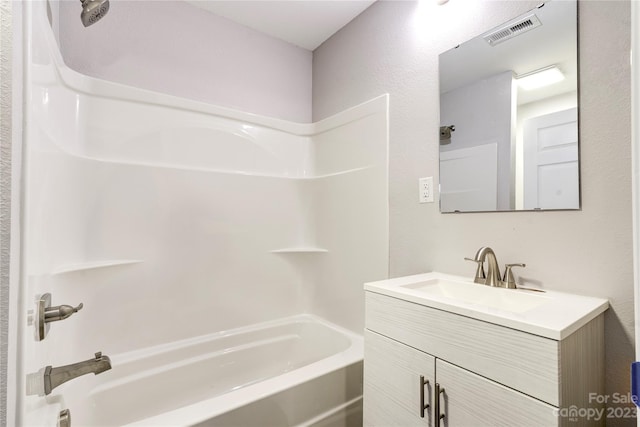 bathroom featuring vanity and washtub / shower combination