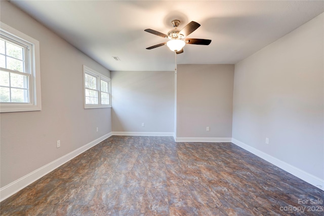 unfurnished room featuring a healthy amount of sunlight and ceiling fan