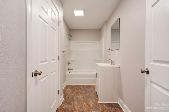 hallway with dark tile flooring and sink