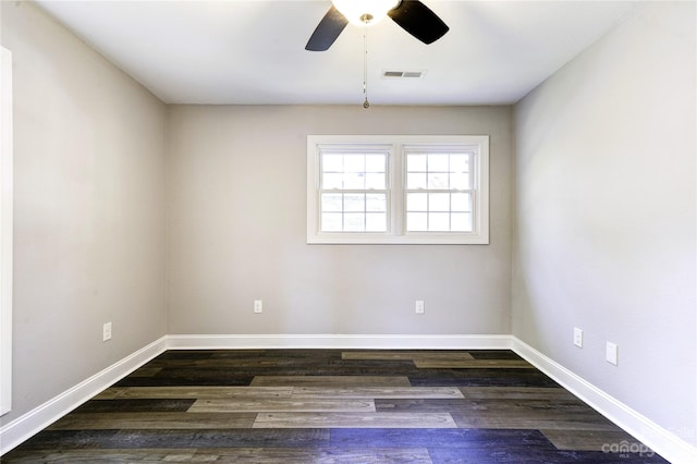 empty room with dark hardwood / wood-style floors and ceiling fan