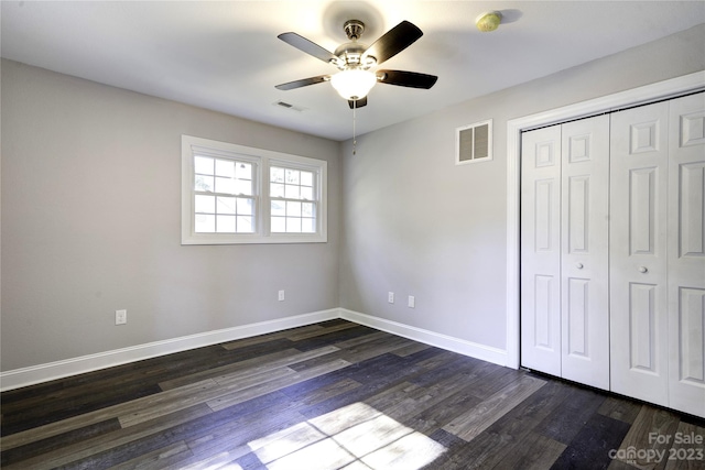 unfurnished bedroom featuring ceiling fan, a closet, and dark hardwood / wood-style floors