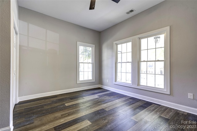 unfurnished room with dark hardwood / wood-style flooring and ceiling fan