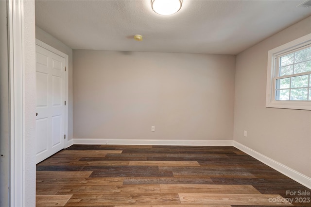 unfurnished room featuring dark hardwood / wood-style flooring