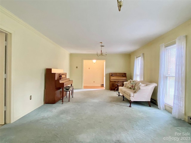 living area with light carpet, crown molding, a notable chandelier, and a baseboard heating unit