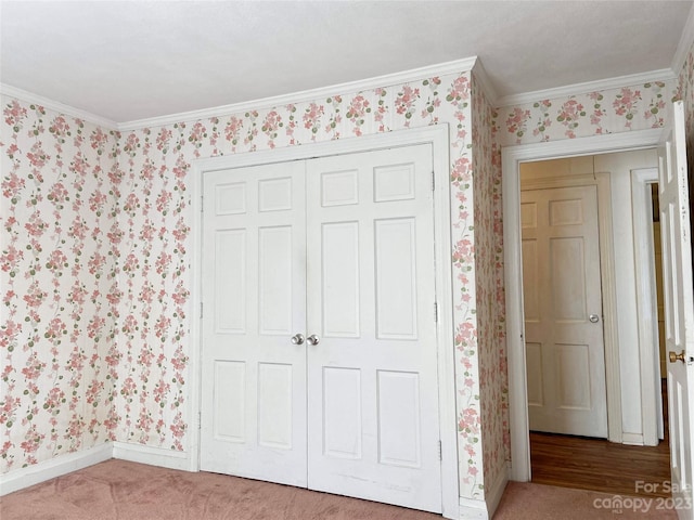 unfurnished bedroom with a closet, crown molding, and light colored carpet