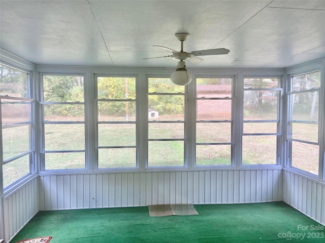 unfurnished sunroom with ceiling fan