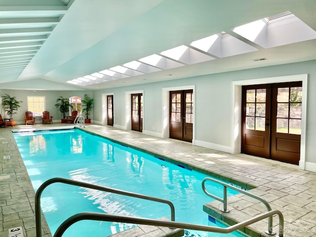 view of pool featuring french doors and a skylight