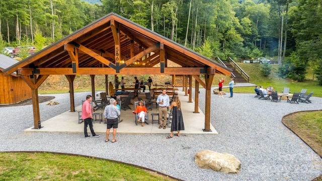 surrounding community featuring a gazebo, an outdoor fire pit, and a patio