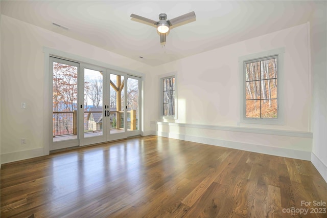 spare room with ceiling fan, hardwood / wood-style flooring, and french doors