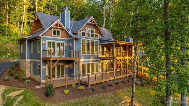 rear view of house featuring a wooden deck