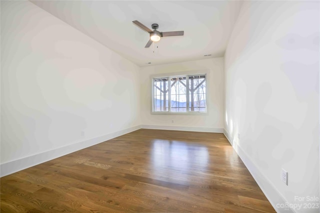 unfurnished room with ceiling fan and dark hardwood / wood-style floors