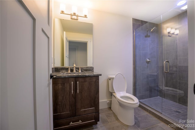 bathroom featuring tile flooring, toilet, an enclosed shower, and vanity with extensive cabinet space