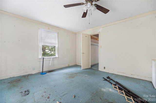 unfurnished room featuring ceiling fan, a textured ceiling, and ornamental molding