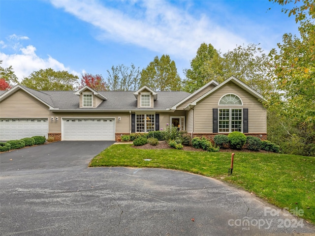 view of front of house with a garage and a front lawn