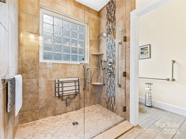 bathroom featuring a shower with door