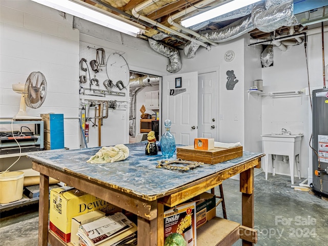 basement featuring a workshop area and water heater