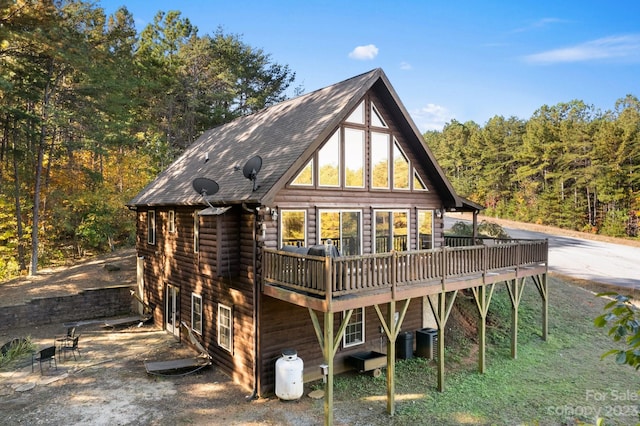 rear view of house featuring a wooden deck and central air condition unit