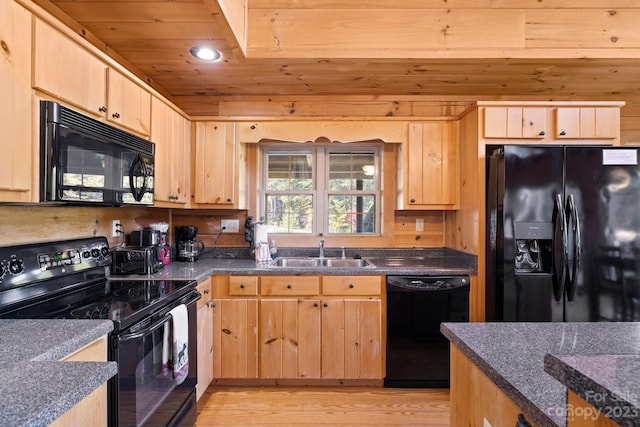 kitchen featuring light hardwood / wood-style flooring, sink, light brown cabinetry, and black appliances