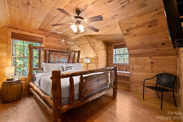 bedroom featuring wooden ceiling, vaulted ceiling, wooden walls, and wood-type flooring