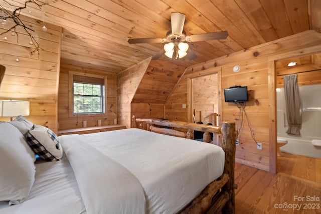 bedroom with ceiling fan, light wood-type flooring, wood walls, wooden ceiling, and vaulted ceiling