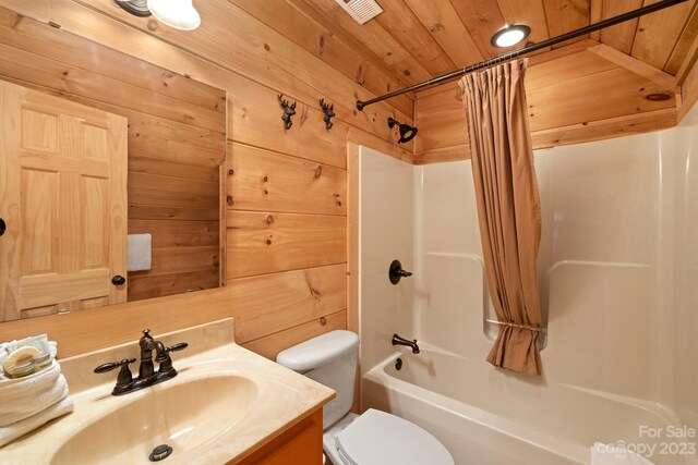 full bathroom with toilet, vanity with extensive cabinet space, wooden ceiling, wood walls, and shower / tub combo with curtain