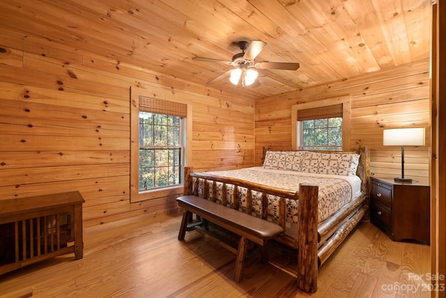 bedroom featuring ceiling fan, multiple windows, and light wood-type flooring