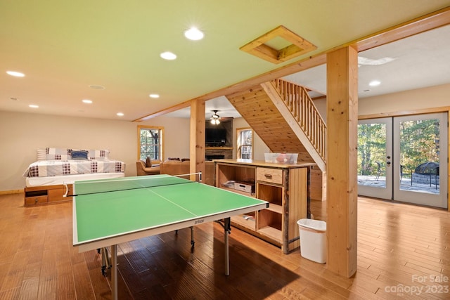 game room with french doors, ceiling fan, and light hardwood / wood-style flooring