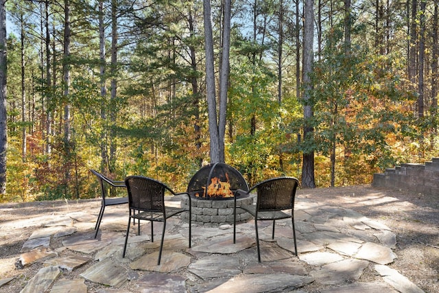 view of terrace with an outdoor fire pit