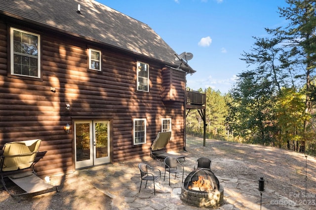 exterior space featuring a balcony and a fire pit