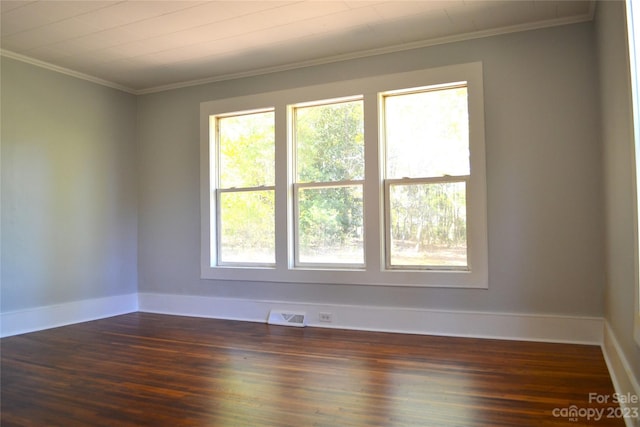 spare room with dark hardwood / wood-style flooring and ornamental molding