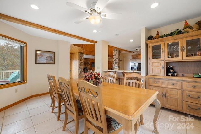 tiled dining space featuring ceiling fan