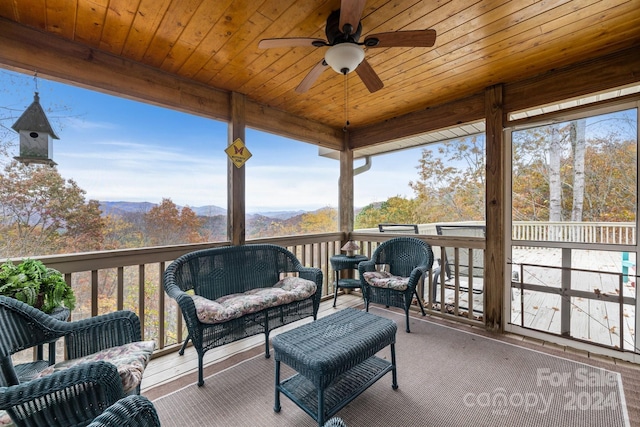 exterior space with a mountain view, ceiling fan, and an outdoor hangout area