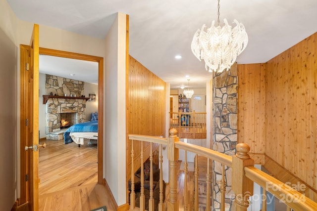 hall with wooden walls and a notable chandelier