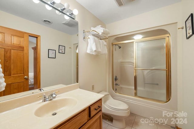 full bathroom featuring enclosed tub / shower combo, toilet, vanity, and tile patterned flooring