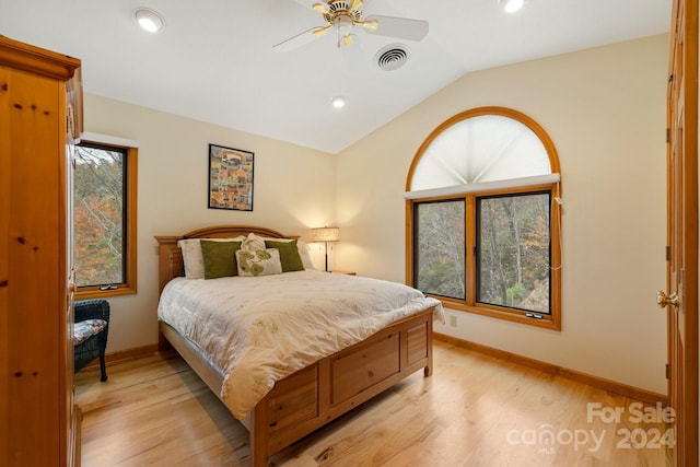 bedroom featuring ceiling fan, light hardwood / wood-style floors, and vaulted ceiling